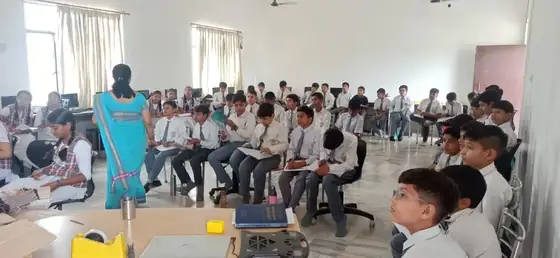 A trainer teaching a school class about robotics